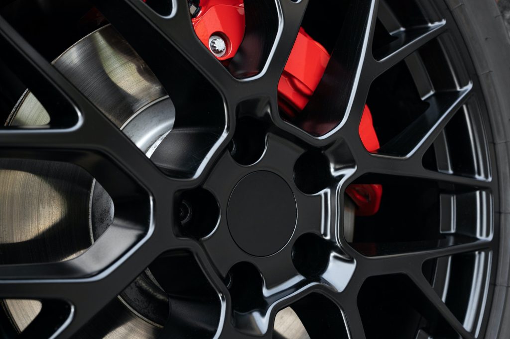 Sport rim and red brake caliper of car